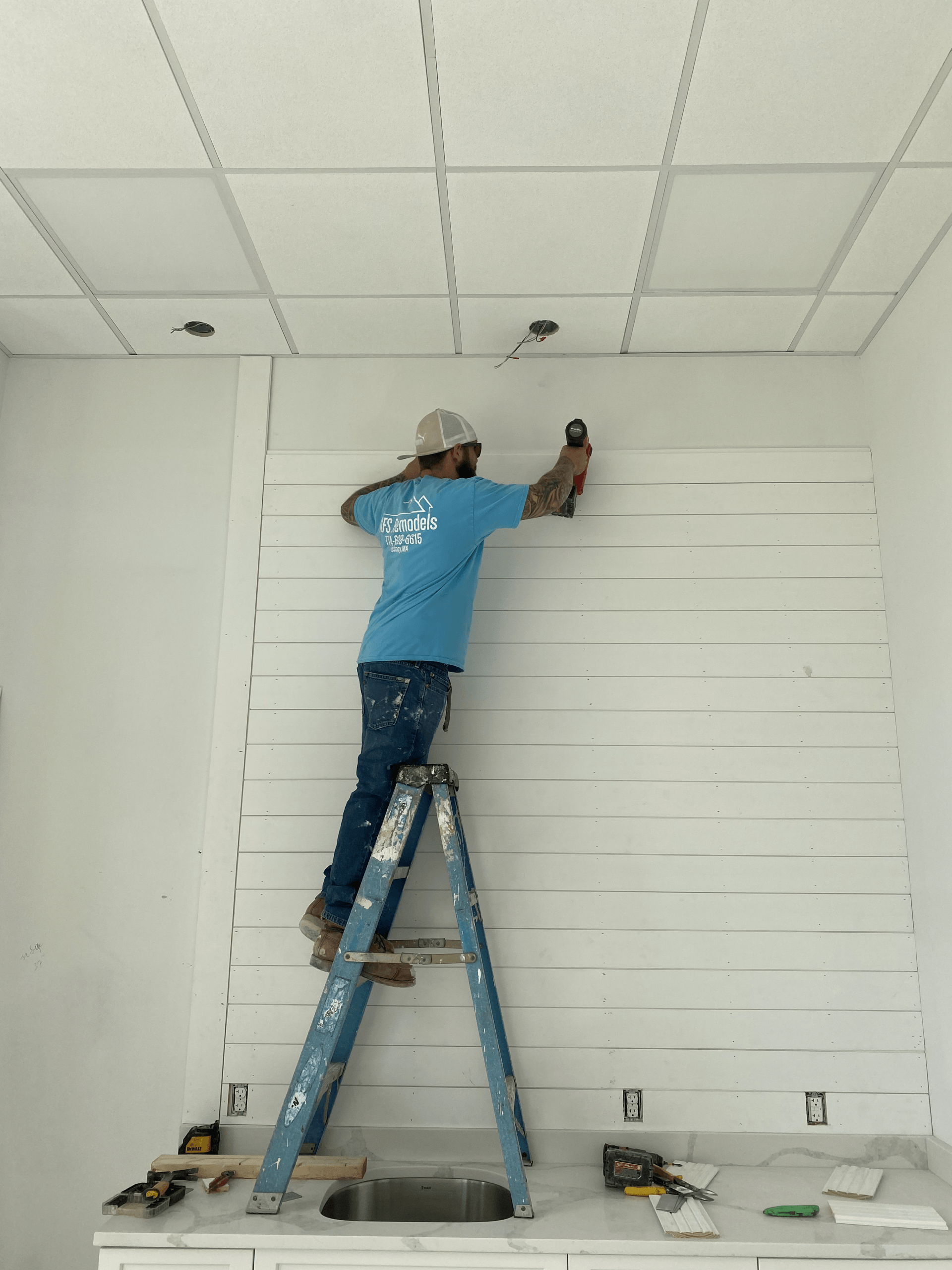 Nick installing a shiplap accent wall
